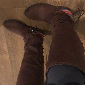 Dark brown boots with bright stripes and laces